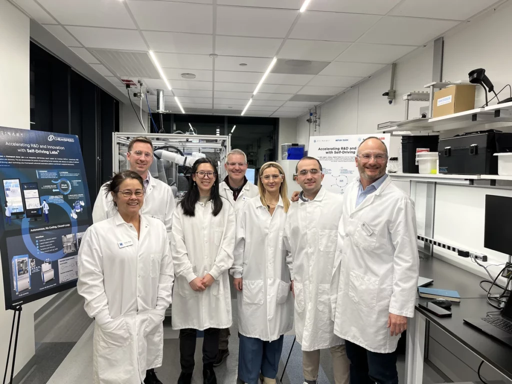 Team of scientists in front of a Self-Driving Lab